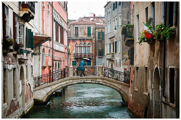 Venice Post Wedding Shoot photography gent with umbrella walking over canal on bridge