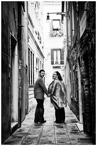 Venice Post Wedding Shoot photography couple looking back in narrow lstreet