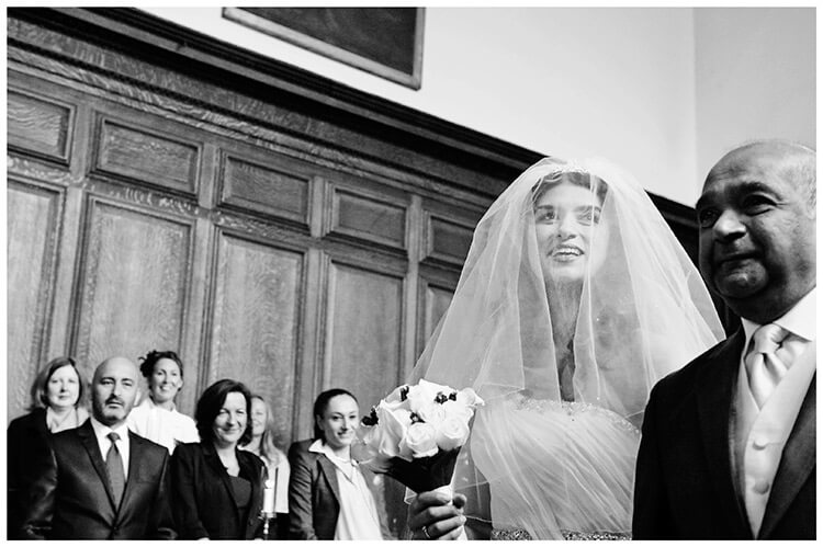 Christ’s College wedding smiling bride guests in chapel