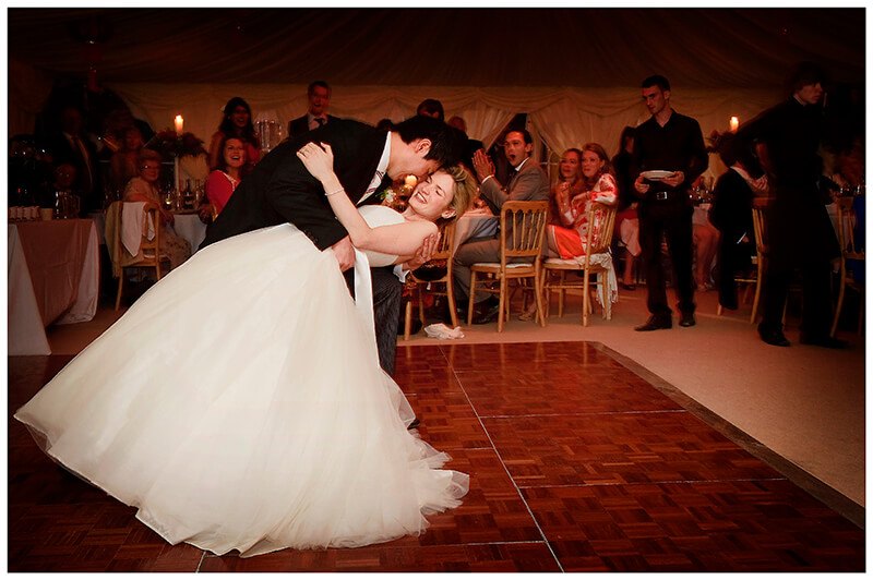 groom dips bride during first dance
