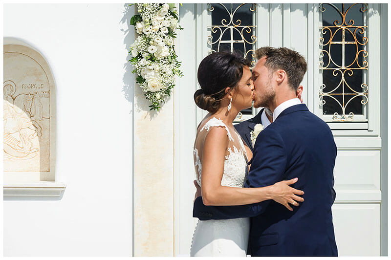 Bride groom kiss at end of ceremony at Royal Myconian Resort Mykonos