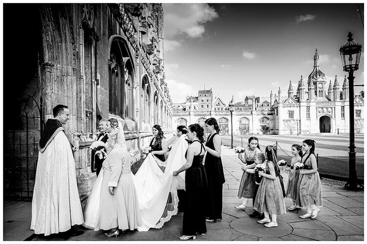 Wedding party arrives at Kings College Cambridge chapel greeted by Vicar favourite wedding photography 2018