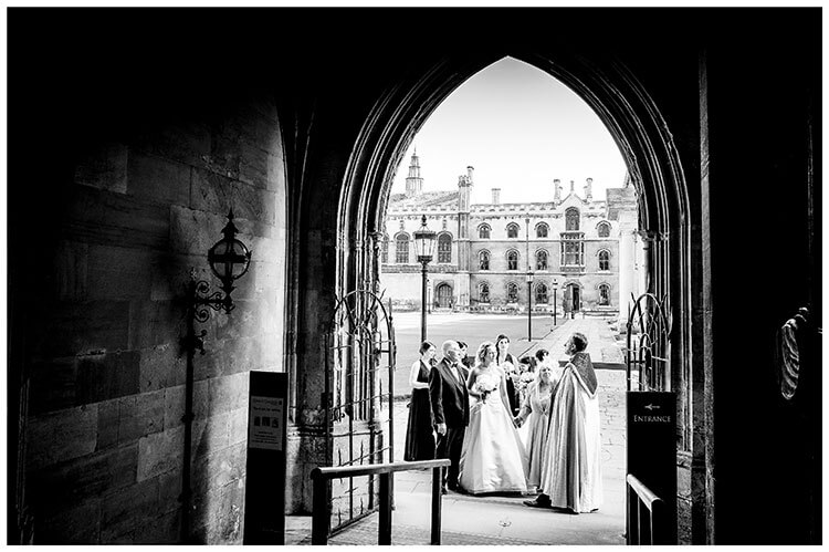 Bridal party at entrance to chapel at Kings College Cambridge viewed from inside chapel