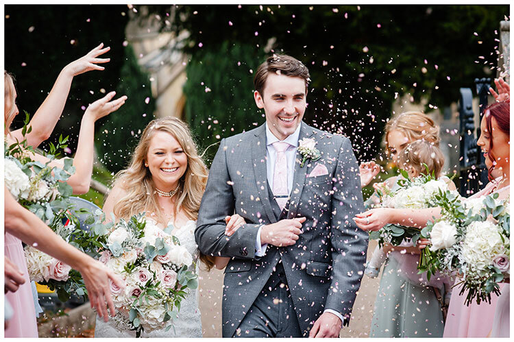 bridesmaids throw confetti at happy bride and groom favourite wedding photography 2018