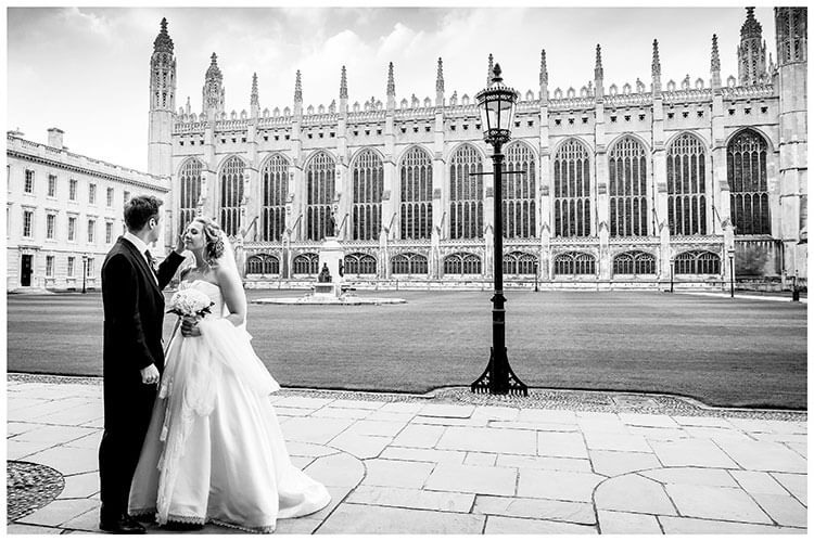 Groom brushes hair away from brides face with Kings College Chapel Cambridge in back ground favourite wedding photography 2018