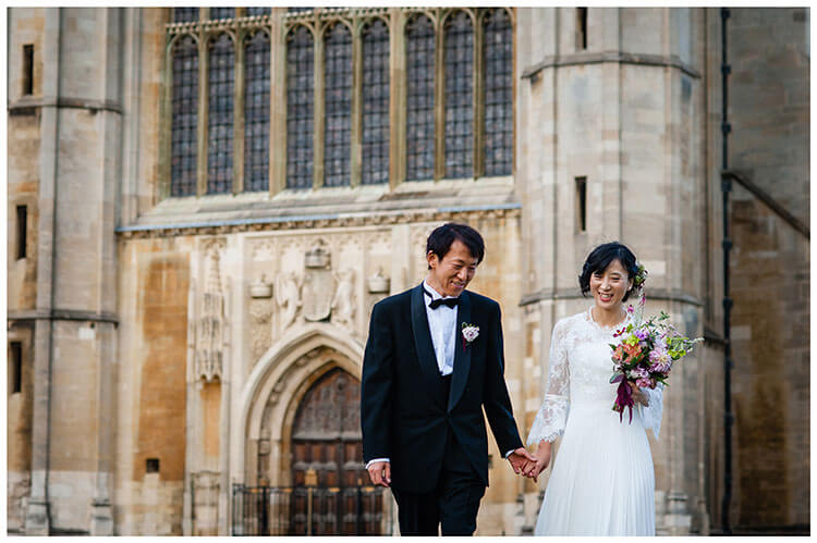 Smiling Asian bride and groom hold hands with Kings College Chapel in Background Favourite wedding photography 2018