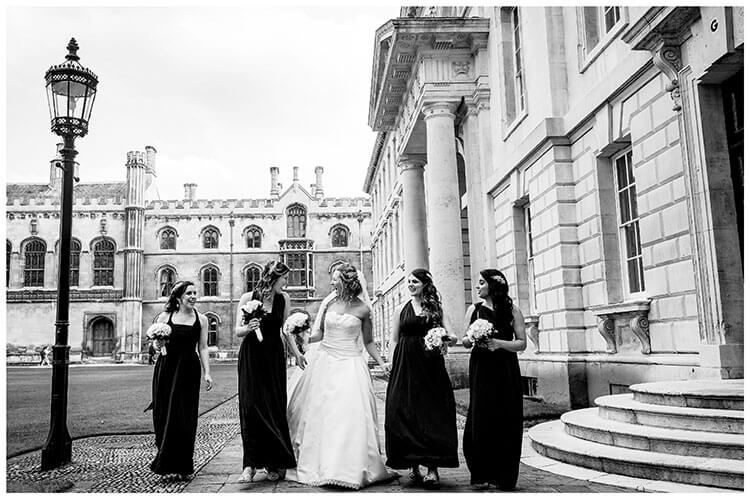 Bride and Bridesmaids walking and laughing at Kings College Cambridge Wedding Favourite Photography 2018