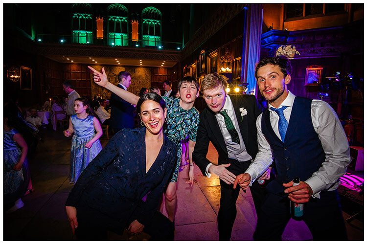 Group of wedding guests strike a pose whilst on the dance floor Kings College Cambridge favourite wedding photography 2018